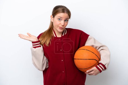 Téléchargez les photos : Young basketball player woman isolated on white background having doubts while raising hands - en image libre de droit
