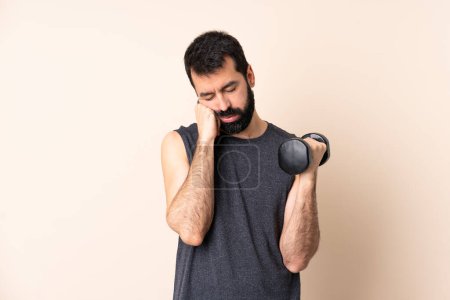 Photo for Caucasian sport man with beard making weightlifting over isolated background with tired and bored expression - Royalty Free Image