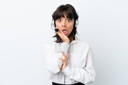 Photo for Telemarketer mixed race woman working with a headset isolated on white background surprised and shocked while looking right - Royalty Free Image
