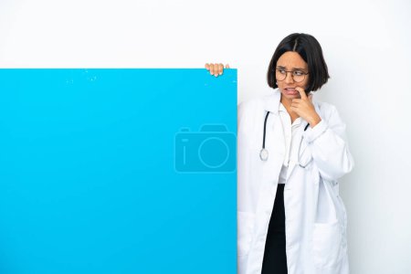 Photo for Young mixed race doctor woman with a big placard isolated on white background nervous and scared - Royalty Free Image