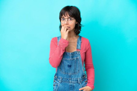 Photo for Young woman with overalls isolated background nervous and scared - Royalty Free Image
