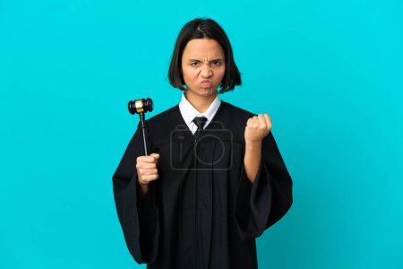 Photo for Judge over isolated blue background with unhappy expression - Royalty Free Image