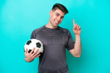 Photo for Young caucasian football player man isolated on blue background showing and lifting a finger in sign of the best - Royalty Free Image