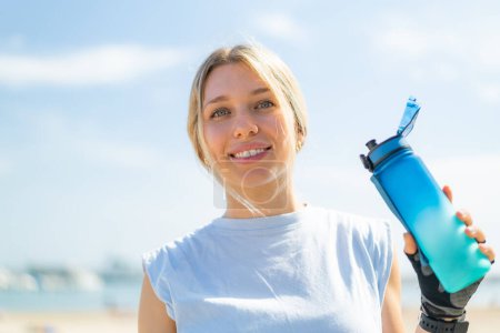 Photo for Young blonde woman at outdoors doing sport with a bottle of water - Royalty Free Image