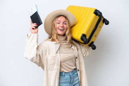 Téléchargez les photos : Young Russian woman isolated on white background in vacation with suitcase and passport - en image libre de droit