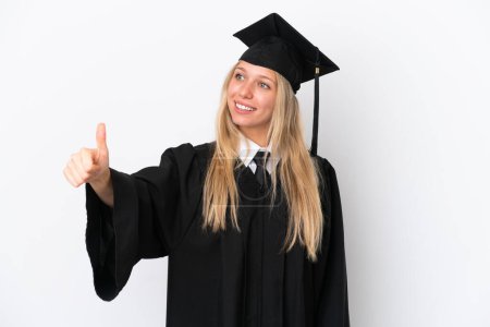Foto de Joven universidad graduado caucásico mujer aislado en blanco fondo dando un pulgar hacia arriba gesto - Imagen libre de derechos
