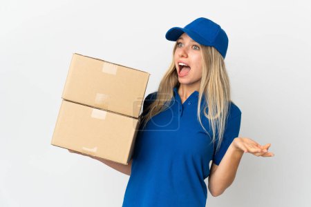 Photo for Young delivery woman isolated on white background with surprise expression while looking side - Royalty Free Image