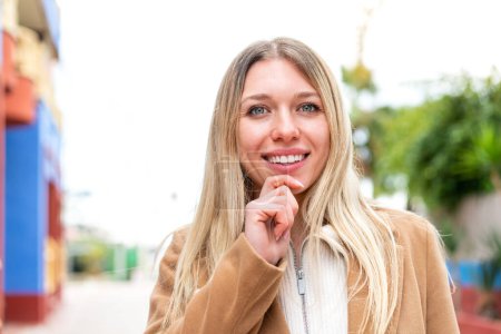 Photo for Young pretty blonde woman at outdoors With happy expression - Royalty Free Image