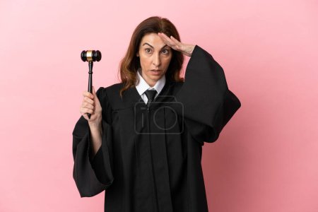 Photo for Middle aged judge woman isolated on pink background with surprise expression - Royalty Free Image