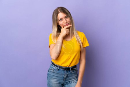 Photo for Young blonde woman isolated on purple background thinking - Royalty Free Image