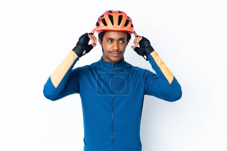 Photo for Young cyclist man with braids over isolated background having doubts and thinking - Royalty Free Image