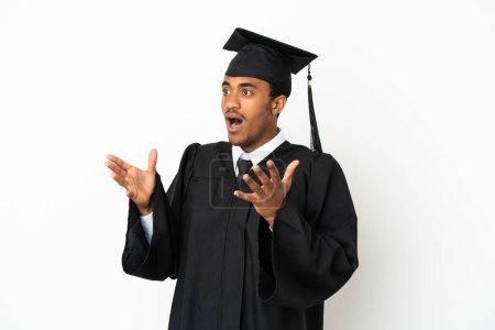 Foto de Negro americano universidad graduado hombre sobre aislado blanco fondo con sorpresa facial expresión - Imagen libre de derechos
