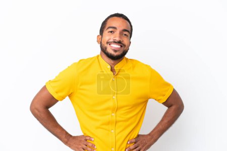 Téléchargez les photos : Young Ecuadorian man isolated on white background posing with arms at hip and smiling - en image libre de droit