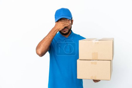 Foto de Delivery Ecuadorian man isolated on white background covering eyes by hands. Do not want to see something - Imagen libre de derechos