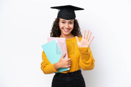 Photo for Arab university graduate woman holding books isolated on white background counting five with fingers - Royalty Free Image