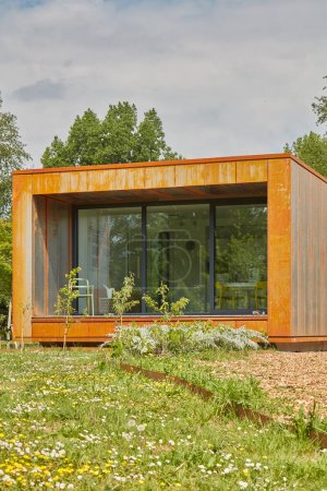 Photo for Almere, The Netherlands - May 17, 2022: Contemporary designed new corten steel tiny house on the Floriade expo in Almere, The Netherlands - Royalty Free Image
