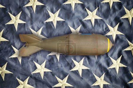Ancient military missile bomb in front of the stars of an American flag