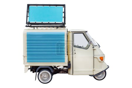 Vintage Italian three wheeled scooter van with advertising banner on the roof isolated on a white background