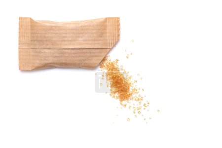 Photo for Spilled cane sugar from a small paper sachet. Preparation for sweetening beverages in a small package - Royalty Free Image