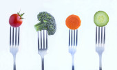 Collage. Vegetables stabbed on a silver fork on the white background. Close-up. Poster #644132464