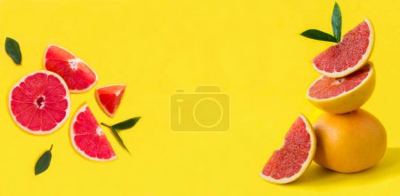Pyramid of grapefruit in balance and chopped of grapefruit on the yellow background. Close-up. Copy space.