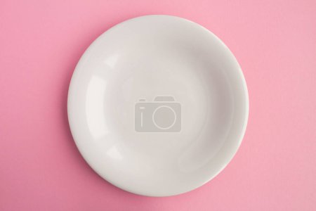 Photo for Empty white plate for text on the pink background. Copy space. Top view. - Royalty Free Image