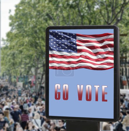 Billboard with the inscription "Go vote", American flag on the background of the street