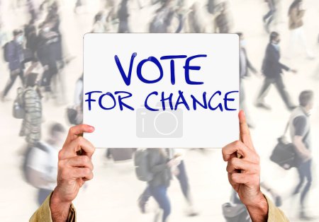 Hands holding a sign with the inscription: vote for change on an abstract background