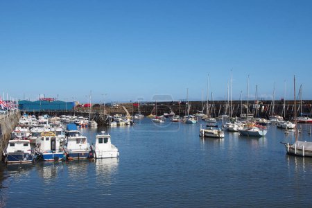 Photo for Scarborough, North Yorkshire, United Kingdom - 12 September 2022 : view of the town of scarborough in summer with yachts and fishing boats moored in the marina - Royalty Free Image