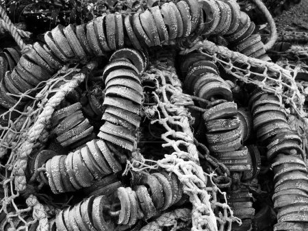 Photo for Monochrome close up of tangled old fishing net rope and floats - Royalty Free Image