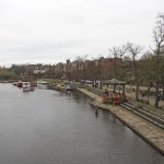 Chester. Cheshire, United Kingdom - 20 March 2024 : View of the river Dee in Chester with trip boats moored on the riverbank and old bandstand