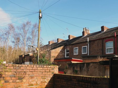 view of a back alley from a yard with brick walls in a typical old english working class terraced street