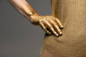 Cropped view of woman in golden dress and shiny paint on hand isolated on grey  t-shirt #616816194