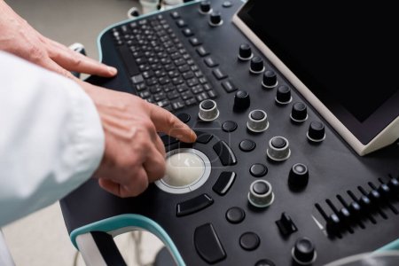 Photo for Partial view of physician using control panel of ultrasound machine - Royalty Free Image