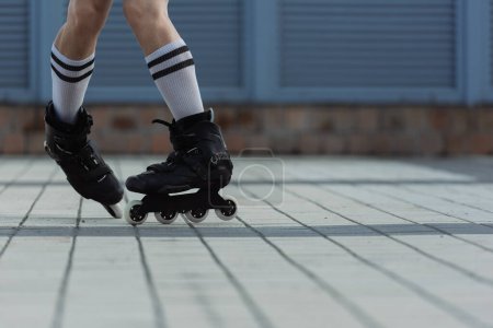 Photo for Partial view of man in roller blades doing trick outdoors - Royalty Free Image