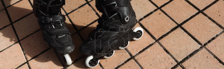 Top view of roller blades outdoors at daytime, banner 