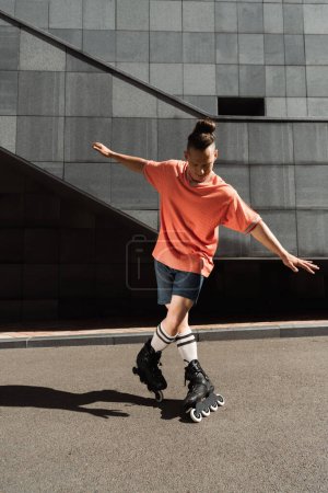 Roller skater in t-shirt and shorts doing trick near building outdoors 