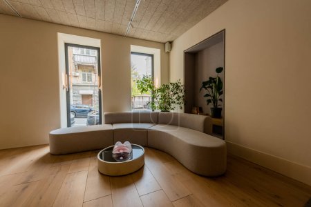 Téléchargez les photos : Modern sofa and coffee table near green plants in luxury hotel lobby - en image libre de droit