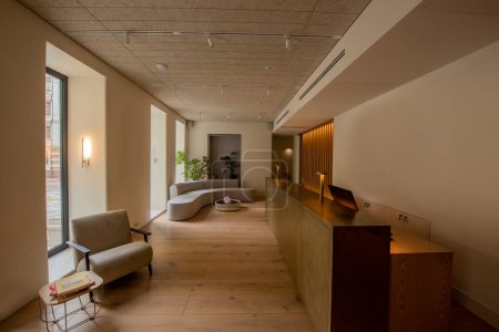 Téléchargez les photos : Interior of luxury hotel lobby with reception desk near modern sofa and armchair - en image libre de droit