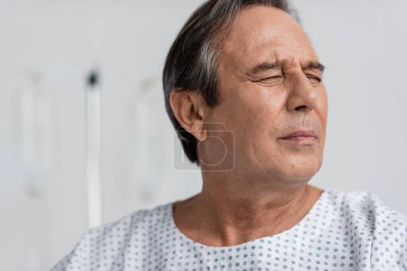 Sick senior patient suffering from pain in clinic