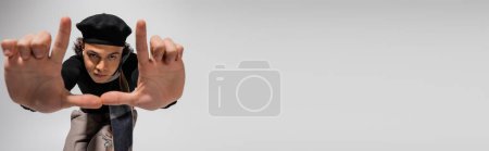 Photo for Trendy african american man in black beret and scarf showing snapshot gesture on grey background, banner - Royalty Free Image
