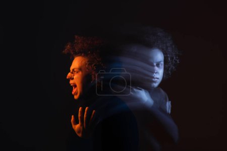 double exposure of depressed and angry african american man with bipolar disorder shouting on dark with orange and blue light