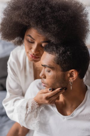 Photo for Curly african american woman with closed eyes touching face of young boyfriend - Royalty Free Image
