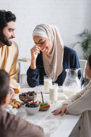 Photo for Positive muslim family having breakfast during ramadan at home - Royalty Free Image