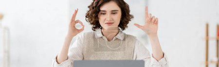 Photo for Curly sign language teacher showing alphabet letters with hands during online lesson, banner - Royalty Free Image