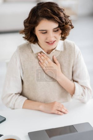 cheerful sign language teacher showing please word during online lesson on laptop 