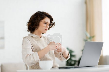 Photo for Young teacher showing two handed gesture while teaching sign language during online lesson - Royalty Free Image