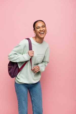 Photo for Excited african american student with backpack standing isolated on pink - Royalty Free Image