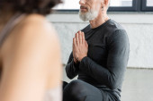 Cropped view of middle aged man practicing anjali mudra in yoga class  puzzle #648175300