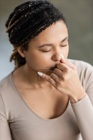 Young african american woman practicing nostril breathing and meditation in yoga studio 